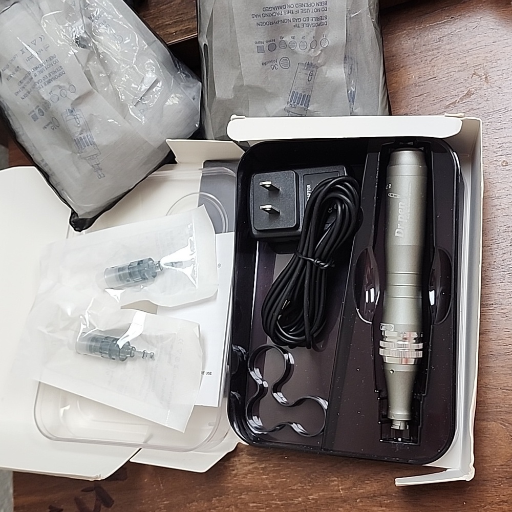 Dr Pen M8 Microneedler with 17- 16 needle and 15- 36 needle tips.